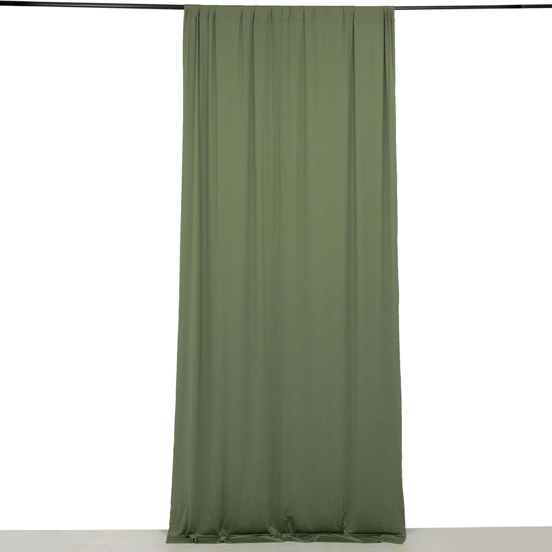 Olive green curtain draped on a rod, showcasing smooth fabric texture.
