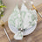 Floral patterned napkin elegantly arranged on a plate with cutlery.
