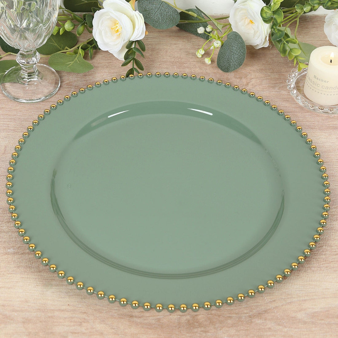 Green decorative plate with gold bead trim on a wooden surface.