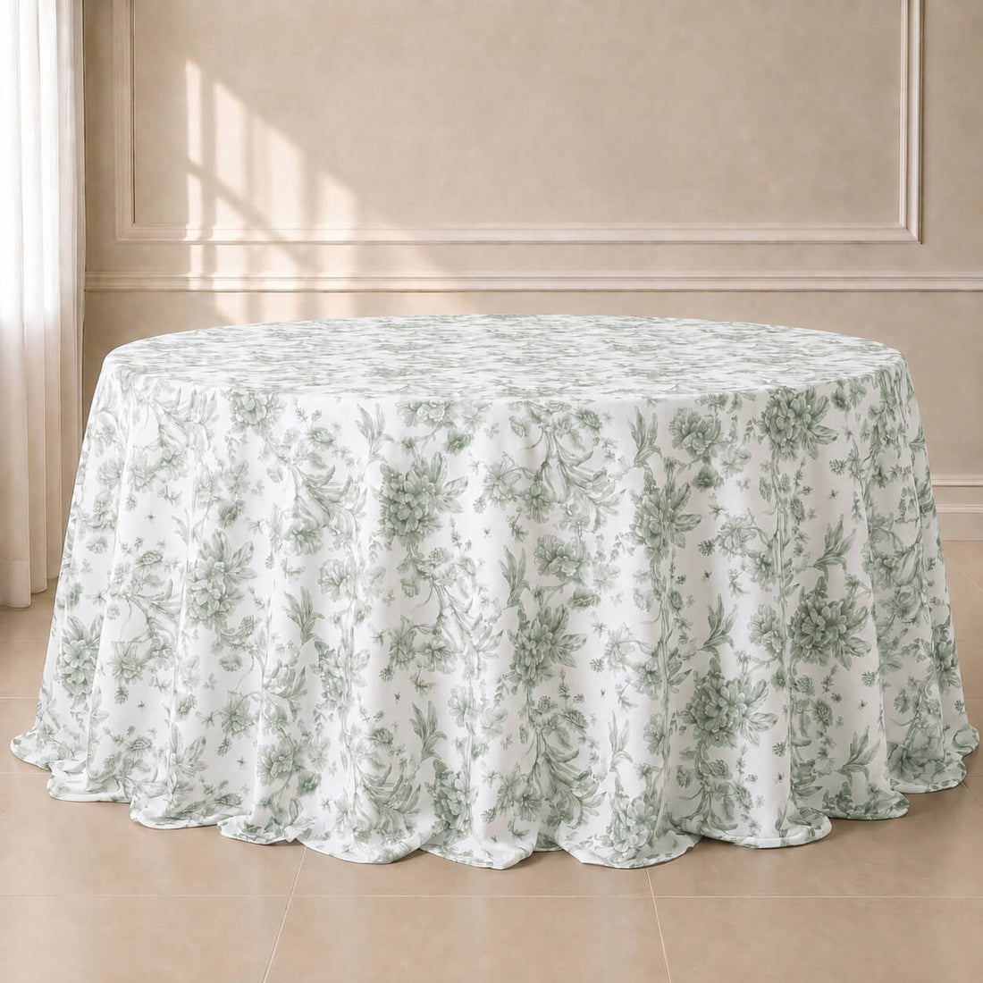 White tablecloth with dusty sage green French toile pattern on a round table.