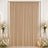 Elegant beige curtain backdrop with white floral arrangements and candles