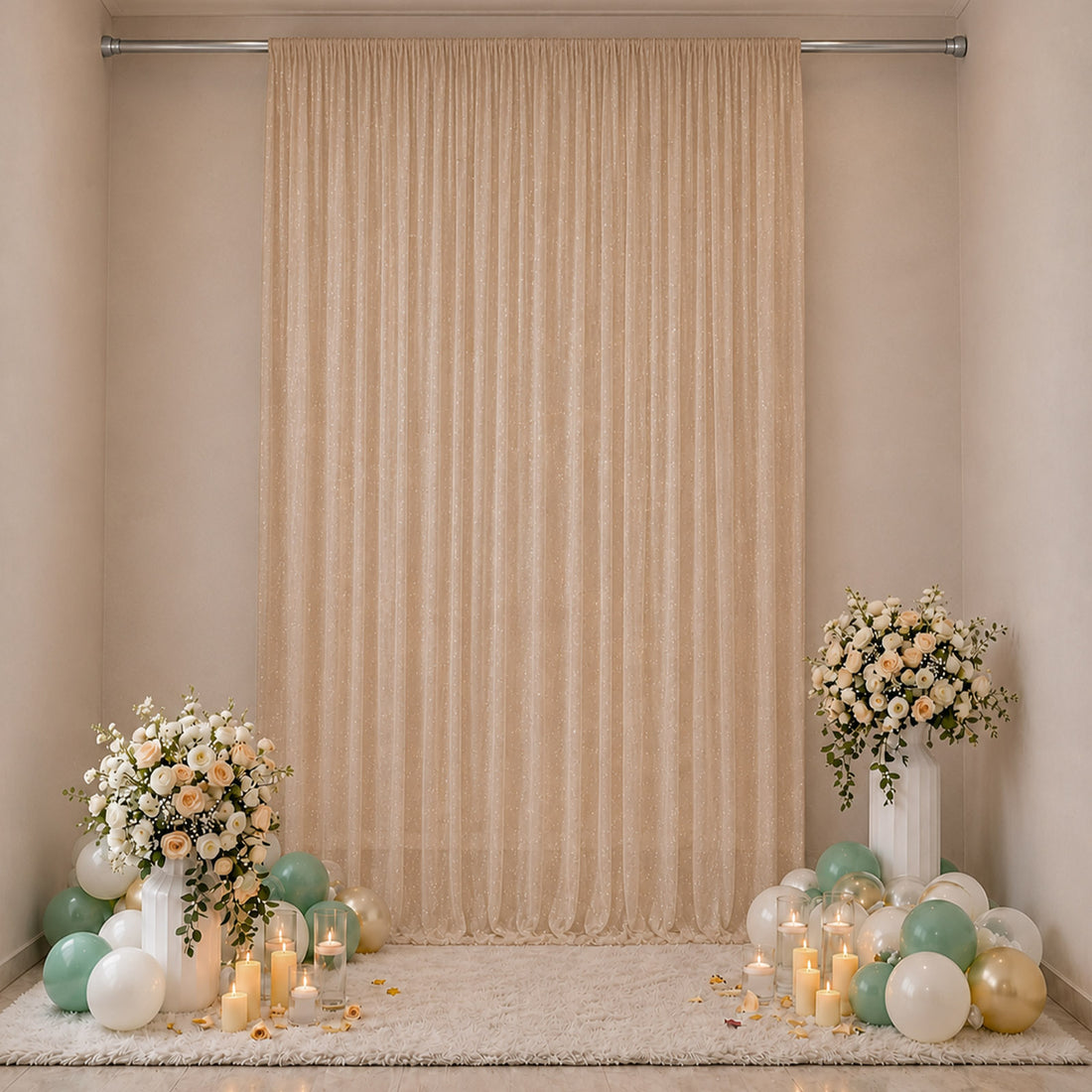 Elegant beige party backdrop with floral arrangements, balloons, and candles