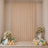 Elegant beige party backdrop with floral arrangements, balloons, and candles
