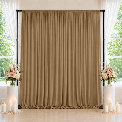 Elegant beige wedding backdrop with floral arrangements and candles