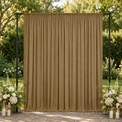 Elegant beige wedding backdrop with floral arrangements and lanterns outdoors