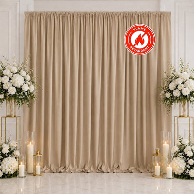Elegant beige wedding backdrop with white floral arrangements and candles