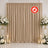 Elegant beige wedding backdrop with white floral arrangements and candles