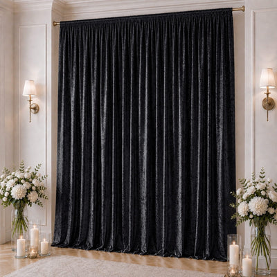 Elegant black velvet curtains in a luxe room with candles and white floral arrangements