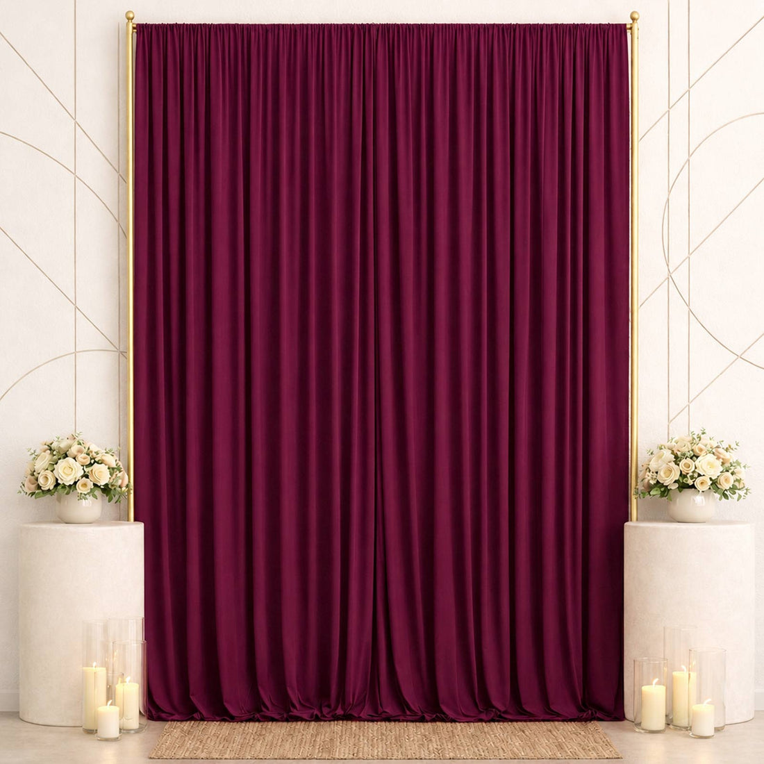 Elegant burgundy velvet backdrop with floral arrangements and candles