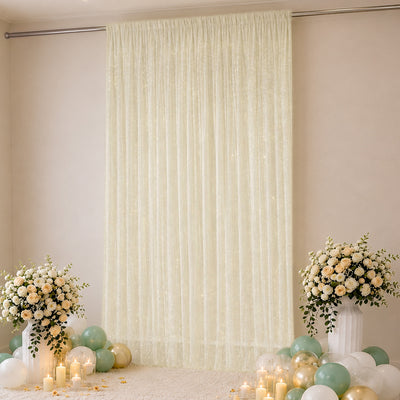 Elegant cream curtain backdrop with floral arrangements and pastel balloons