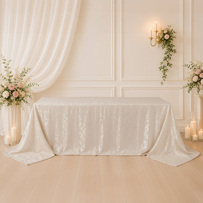 Elegant cream lace tablecloth with floral decor and candles in a romantic setting