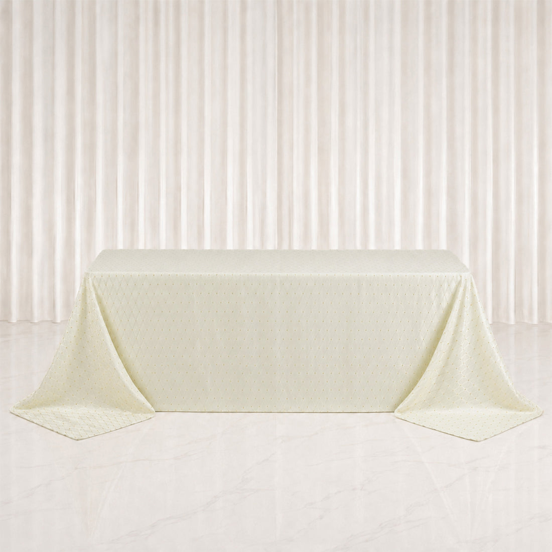 Elegant cream tablecloth draped over rectangular table in minimalist studio setting
