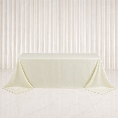 Elegant cream tablecloth draped over rectangular table in minimalist studio setting