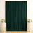 Elegant dark green curtain backdrop with floral arrangements and candles