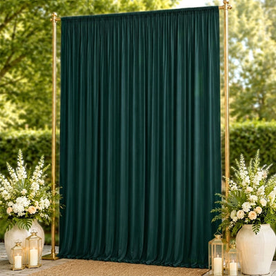 Elegant dark green draped backdrop with gold frame and floral lantern decor