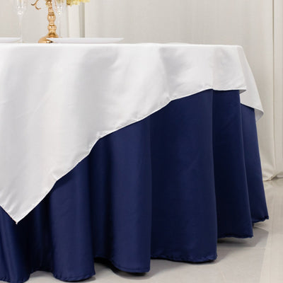 Elegant navy and white tablecloth draped over a round table.