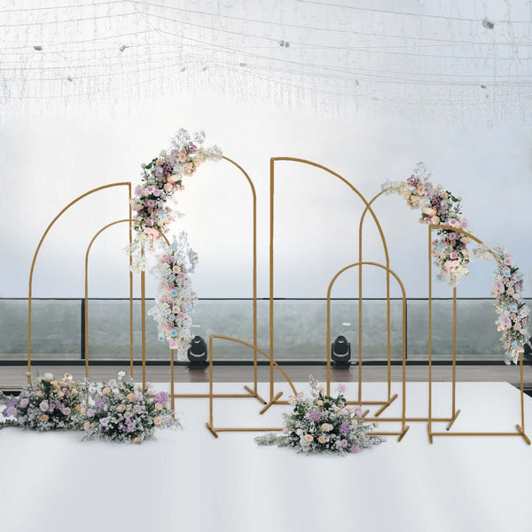 Floral arch backdrop for events with gold frames and pastel flowers.