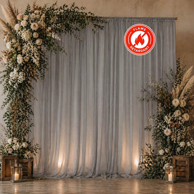 Elegant floral wedding backdrop with gray drapes and lanterns