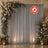 Elegant floral wedding backdrop with gray drapes and lanterns