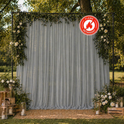 Elegant floral wedding backdrop with sheer drapes and flame retardant sign