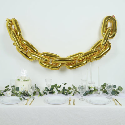 Gold balloon chain decoration for party table setting.