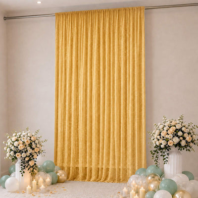 Elegant gold curtain backdrop with floral arrangements and pastel balloons