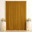 Elegant gold curtain backdrop with white floral arrangements and candles