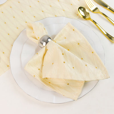 Elegant gold polka dot napkin with silver ring and gold cutlery table setting