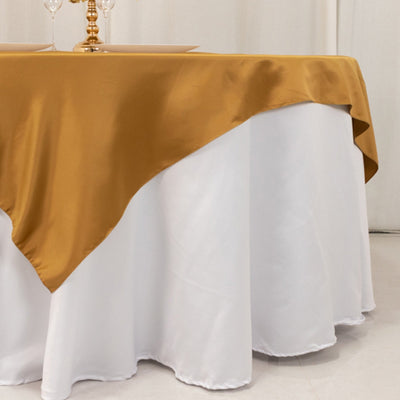 Gold satin tablecloth draped elegantly over a white table.