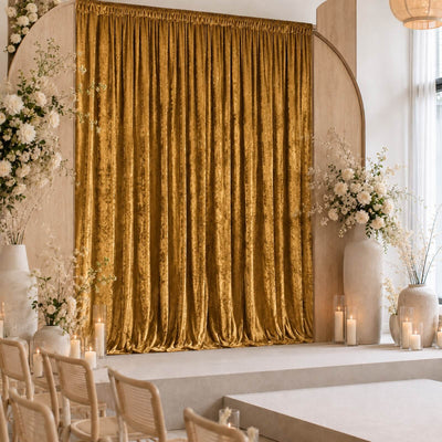 Elegant gold wedding stage backdrop with floral arrangements and candles
