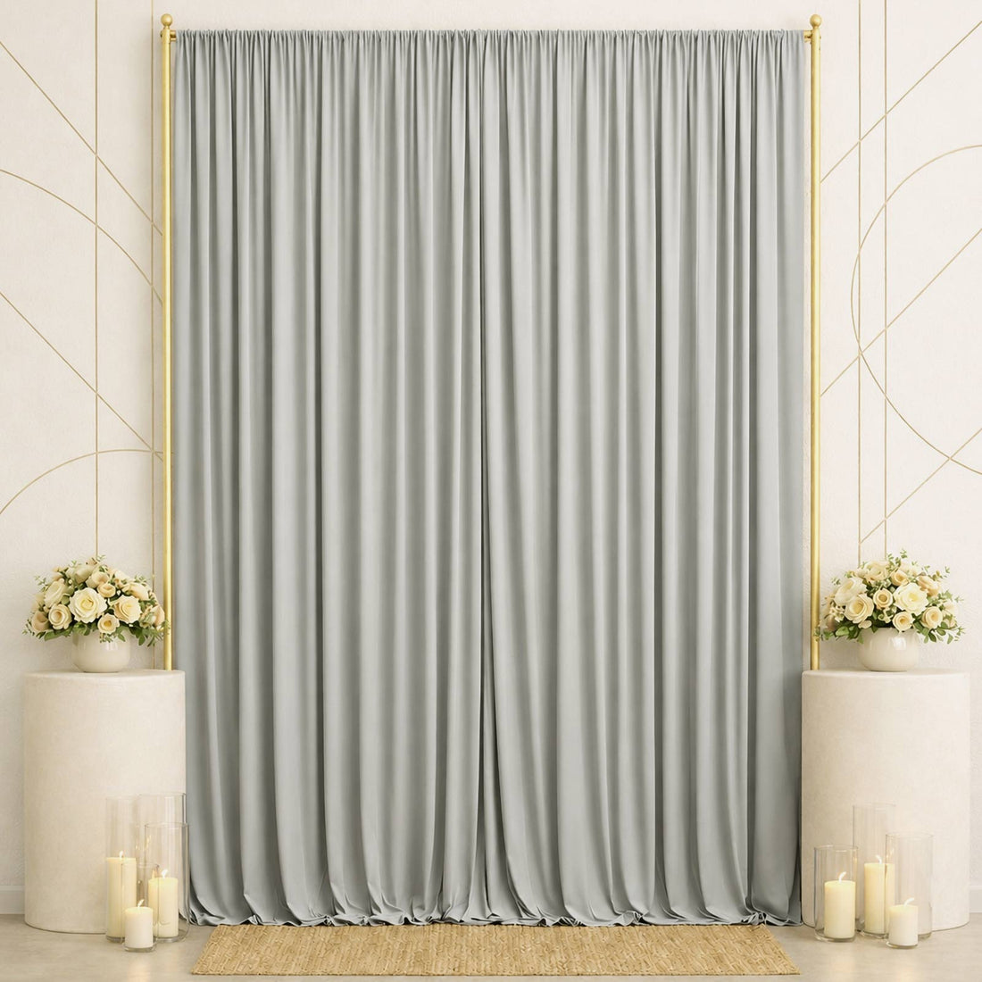 Elegant gray wedding backdrop with gold frame, floral arrangements, and candles