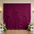 Elegant magenta draped backdrop with floral wedding decor and wall sconces