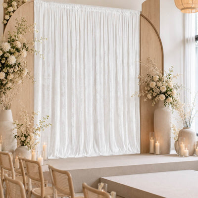 Elegant minimalist wedding ceremony stage with floral arrangements and candles