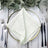 Elegant light green napkin neatly folded on a decorative plate with cutlery. #whtbkgd