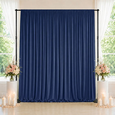 Elegant navy blue curtain backdrop with floral arrangements and candles