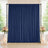 Elegant navy blue curtain backdrop with floral arrangements and candles
