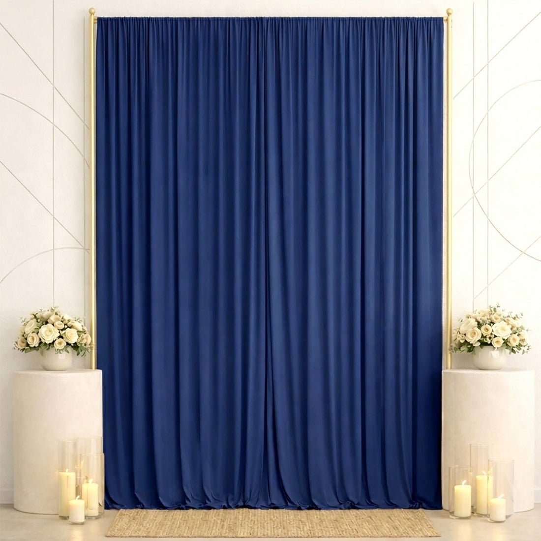 Elegant navy blue curtain backdrop with white floral arrangements and candles