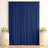 Elegant navy blue curtain backdrop with white floral arrangements and candles