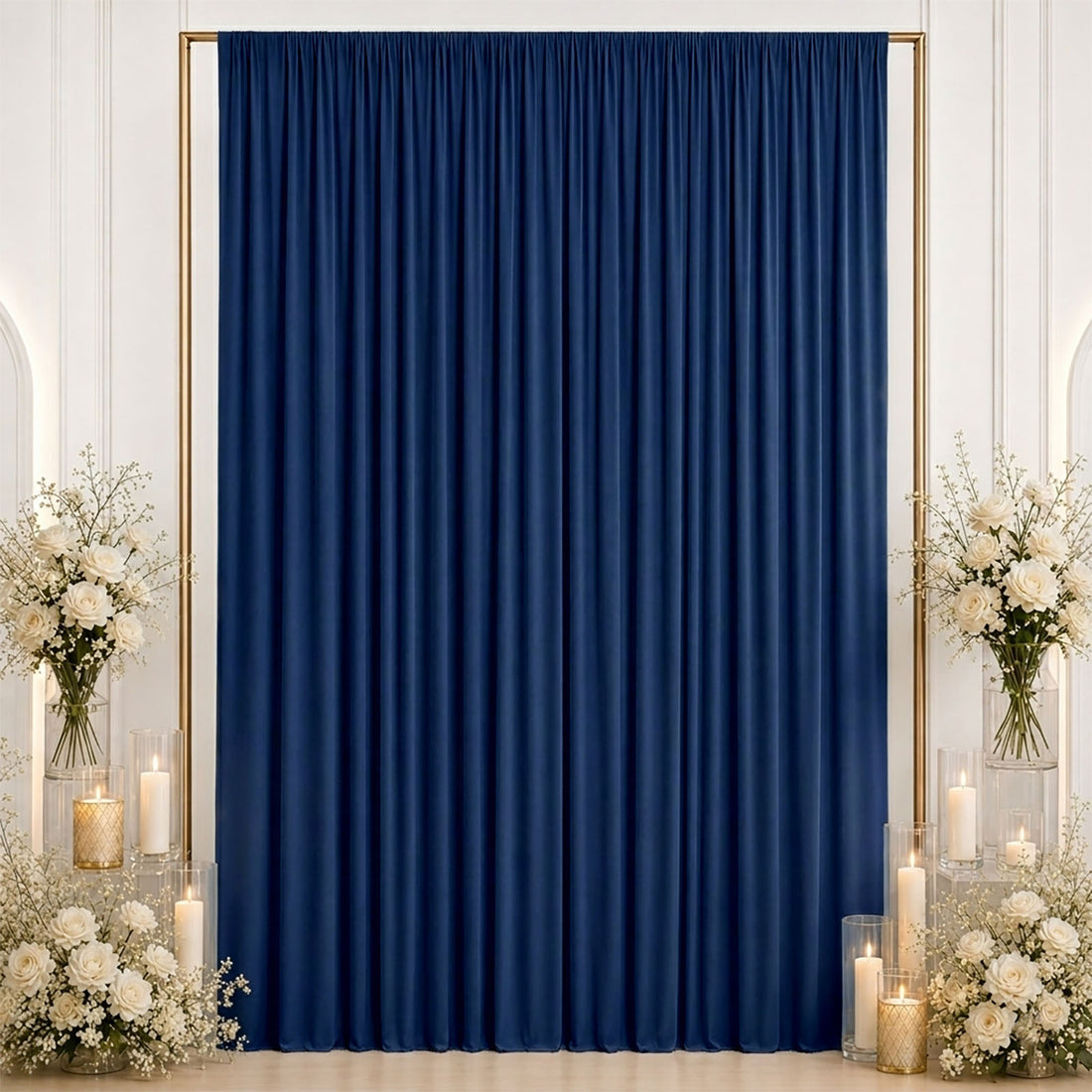Elegant navy blue curtain backdrop with white floral arrangements and candles