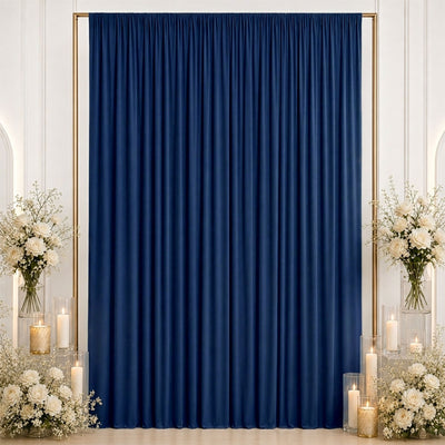 Elegant navy blue curtain backdrop with white floral arrangements and candles