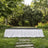 Elegant outdoor stage in a lush garden with white skirted table setting