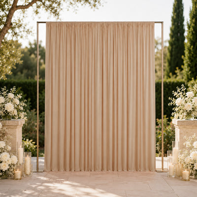 Elegant outdoor wedding backdrop with beige draped curtains and floral decor