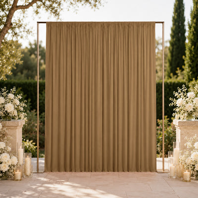 Elegant outdoor wedding backdrop with gold draped curtain and white floral arrangements