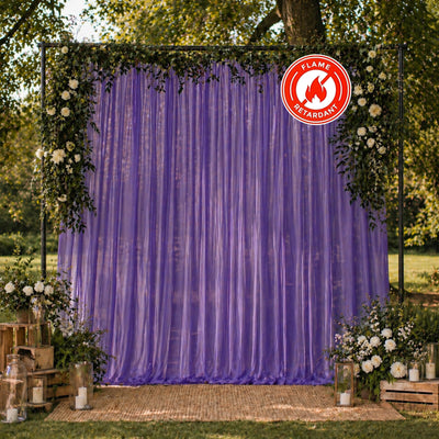 Elegant outdoor wedding backdrop with purple drapes and floral arch, flame retardant