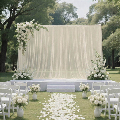 Elegant outdoor wedding ceremony setup with white floral arch and aisle petals