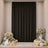 Elegant party backdrop with black curtain, floral arrangements, candles, and balloons