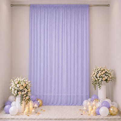 Elegant pastel lavender party backdrop with flowers, balloons, and candles