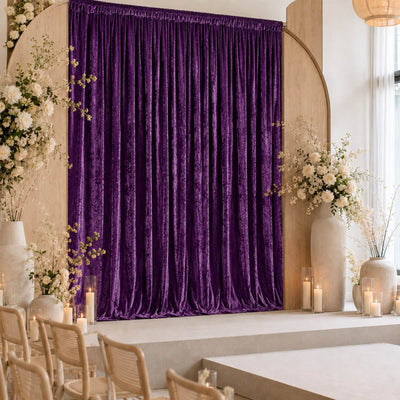 Elegant purple velvet wedding stage with floral decor and candles