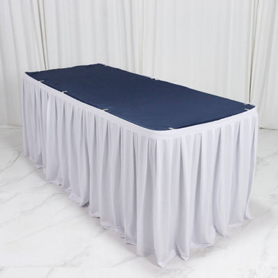 Elegant rectangular banquet table with navy top and white table skirt
