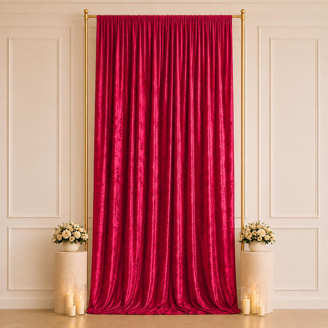 Elegant red velvet curtain backdrop with floral pedestals and candles